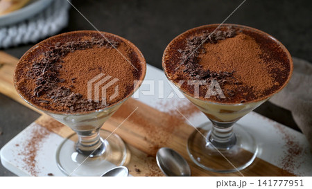 Two Portions of Traditional Tiramisu Served in Elegant stemmed cocktail  Glasses 141777951