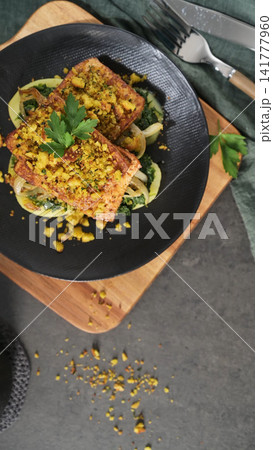 Baked Tofu with Herb Crust over Wilted Greens and Sliced Potatoes 141777960