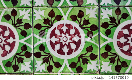 Traditional Portuguese ceramic tiles with intricate green and burgundy floral patterns Traditional Portuguese ceramic tiles with intricate green and burgundy floral patterns 141778019