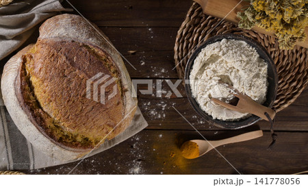 Artisan Bread Loaf with Bowl of Flour on Rustic Table Artisan Bread Loaf with Bowl of Flour on Rustic Table 141778056