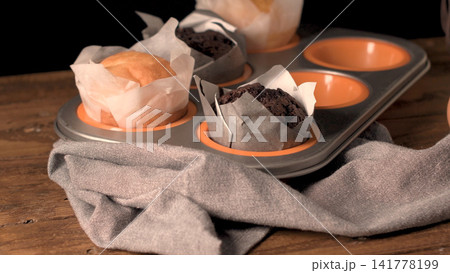 Freshly baked assorted muffins in a muffin tin Freshly baked assorted muffins in a muffin tin 141778199