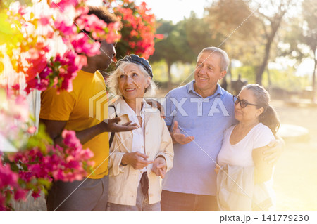 Portrait of mature positive males and females talking outdoors Portrait of mature positive males and females talking outdoors 141779230