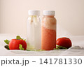 two bottles of fresh tomato juice accompanied by ripe tomatoes on a clean surface healthy nutrition for beverage packaging, food advertising, restaurant menus, recipe books, supermarket catalogs 141781330