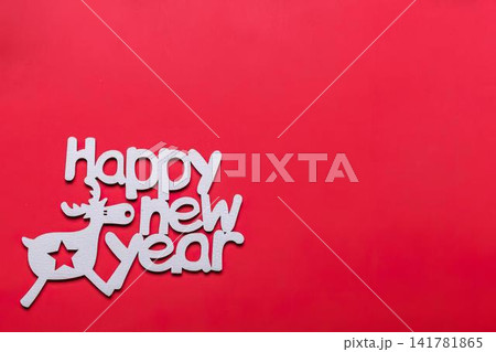 Happy new year message with cute reindeer on red background 141781865