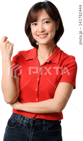 Asian woman smiling in red shirt with folded arms and raised hand showing friendly confidence against transparent background Asian woman smiling in red shirt with folded arms and raised hand showing friendly confidence against transparent background 141782444