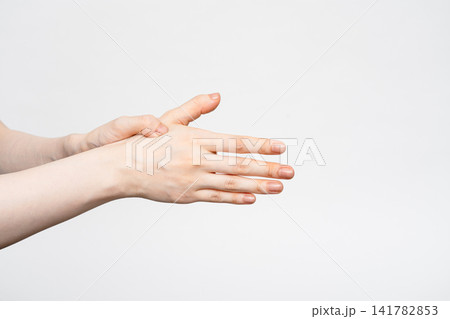 手の甲に手を重ねて温める女性の両手 手の甲に手を重ねて温める女性の両手 141782853