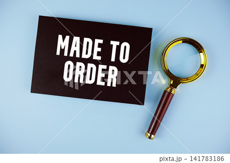 Made to Order text with Magnifying glass on blue background Made to Order text with Magnifying glass on blue background 141783186
