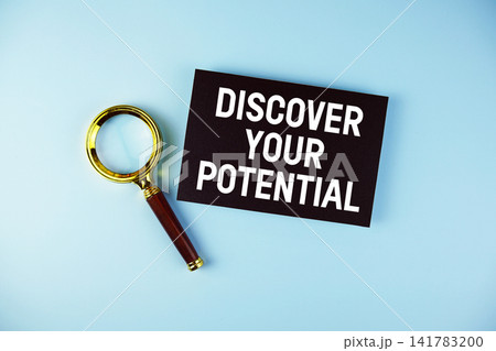 Discover Your Potential text with Magnifying glass on blue background 141783200