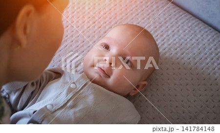 Young mother bonding with her smiling newborn baby Young mother bonding with her smiling newborn baby 141784148