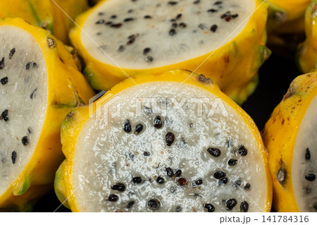 Cut ripe yellow pitahaya fruits close up view. Cut ripe yellow pitahaya fruits close up view. 141784316