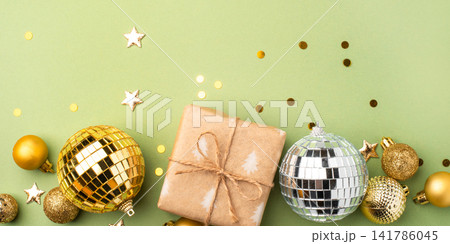 Christmas gift with ornaments on a green background Christmas gift with ornaments on a green background 141786045