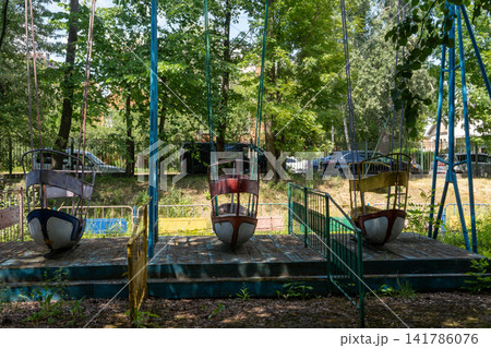 Old Abandoned Boat Swing Ride in City Park Old Abandoned Boat Swing Ride in City Park 141786076