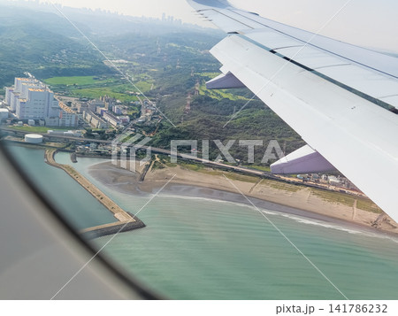 Airplane wing view over Tokyo coastline and sea in Japan Airplane wing view over Tokyo coastline and sea in Japan 141786232