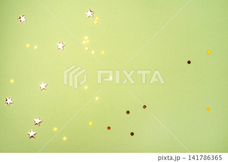 Gold confetti on green background Gold confetti on green background 141786365