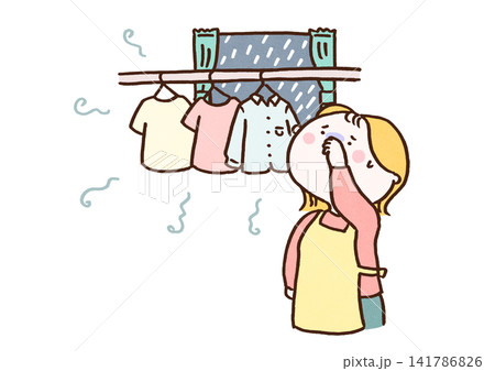 部屋干しした洗濯物の生乾き臭に鼻を押さえる女性(雨の日の家事) 部屋干しした洗濯物の生乾き臭に鼻を押さえる女性(雨の日の家事) 141786826