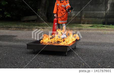 fire prevention. corporate safety - exercise during a firefighting course 141787601