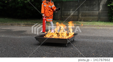 fire prevention. corporate safety - exercise during a firefighting course 141787602