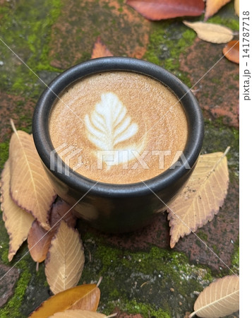A beautifully crafted latte, featuring creamy foam art on top of rich espresso. Perfect for coffee-related projects, this image captures the warmth and inviting nature of a classic cafe experience. A beautifully crafted latte, featuring creamy foam art on top of rich espresso. Perfect for coffee-related projects, this image captures the warmth and inviting nature of a classic cafe experience. 141787718