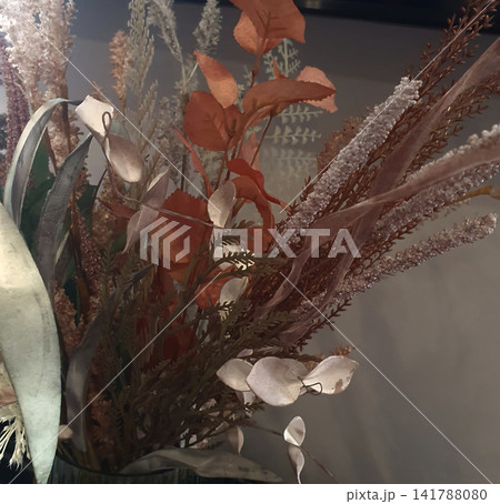 Elegant bouquet of dried flowers and plants with terracotta leaves, pampas grass, and eucalyptus in a modern interior setting Elegant bouquet of dried flowers and plants with terracotta leaves, pampas grass, and eucalyptus in a modern interior setting 141788080
