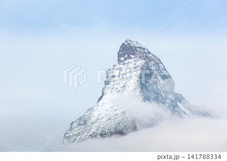 Matterhorn Swiss Alps Switzerland iconic snowy pyramid mountain peak, fog clouds Matterhorn Swiss Alps Switzerland iconic snowy pyramid mountain peak, fog clouds 141788334