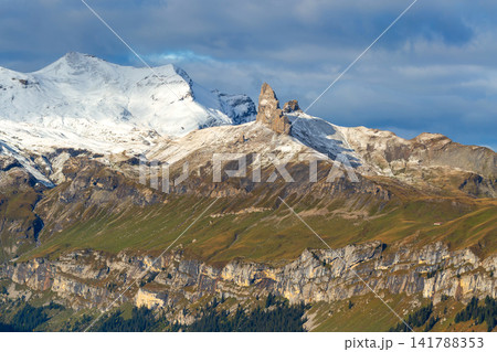 Lobhorner Bernese Oberland Swiss Alps Switzerland sharp rocky peak Grosses Lobhorn and snow covered mountains against cloudy blue sky Lobhorner Bernese Oberland Swiss Alps Switzerland sharp rocky peak Grosses Lobhorn and snow covered mountains against cloudy blue sky 141788353