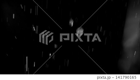 High speed close up of falling rain droplets isolated on a black background creating a realistic weather VFX overlay perfect for cinematic compositing visual effects motion graphics and atmospheric 141790165