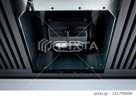 Extractor motor inside modern black cooker hood Extractor motor inside modern black cooker hood 141790666