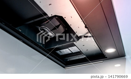 Modern black cooker hood with range hood filter removed showing extractor motor inside Modern black cooker hood with range hood filter removed showing extractor motor inside 141790669