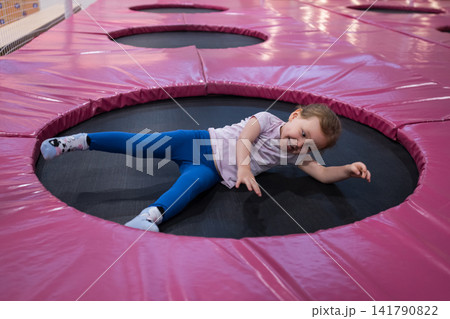 Happy child playing and laughing at trampoline park Happy child playing and laughing at trampoline park 141790822