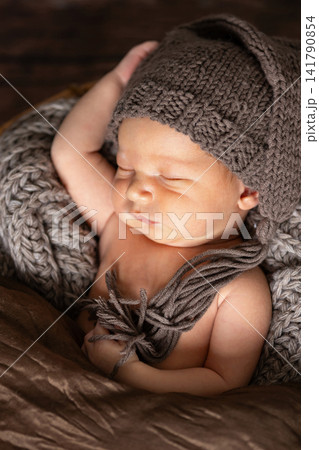 Newborn baby sleeping peacefully with knitted hat and blanket Newborn baby sleeping peacefully with knitted hat and blanket 141790854