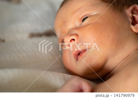 Newborn baby sleeping peacefully showing innocence and new life Newborn baby sleeping peacefully showing innocence and new life 141790979