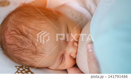 Newborn baby breastfeeding, receiving natural nutrition and bonding Newborn baby breastfeeding, receiving natural nutrition and bonding 141791486
