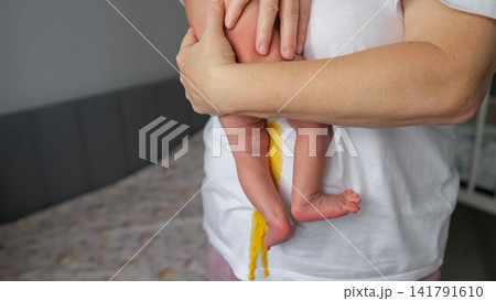 Parent holding newborn with messy diaper blowout Parent holding newborn with messy diaper blowout 141791610
