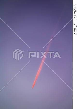 Airplane contrail crossing purple sky at sunset Airplane contrail crossing purple sky at sunset 141792380