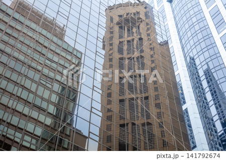 Glass Facades with Reflections of Skyscrapers Glass Facades with Reflections of Skyscrapers 141792674