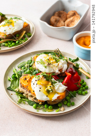 This meal features gluten free bread sandwiches topped with zucchini caviar and poached egg. It includes roasted red peppers and green peas, served with baked pears This meal features gluten free bread sandwiches topped with zucchini caviar and poached egg. It includes roasted red peppers and green peas, served with baked pears 141792948