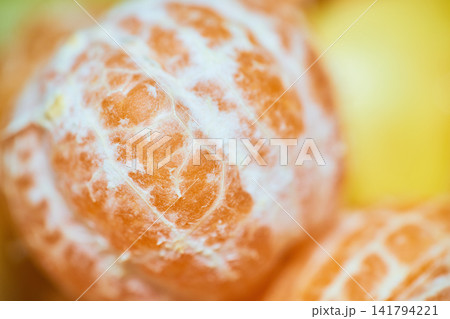 Close-up macro shot of fresh juicy tangerine peel texture showing rich citrus fruit details Close-up macro shot of fresh juicy tangerine peel texture showing rich citrus fruit details 141794221