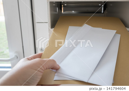 Postbox for letters in modern apartment house. The letter in metal white mailbox in lobby of building. Postbox for letters in modern apartment house. The letter in metal white mailbox in lobby of building. 141794604