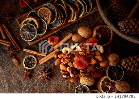 Dried fruits and nuts on a brown vintage background. Dried fruits and nuts on a brown vintage background. 141794795