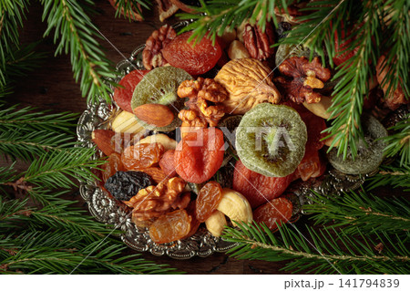Assorted dried fruits and nuts on a silver tray. Assorted dried fruits and nuts on a silver tray. 141794839
