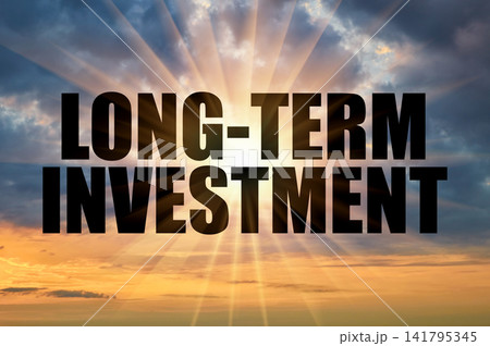 Long-term investment conceptual phrase on a golden evening sky with bright rays 141795345
