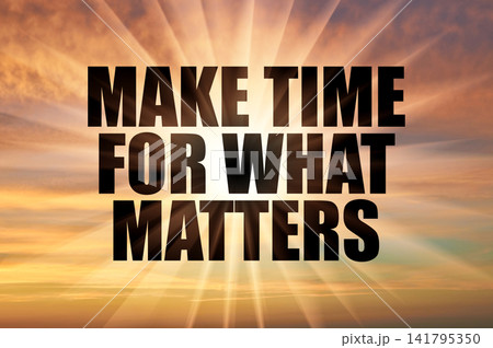 Make time for what matters phrase against a golden evening sky with bright rays Make time for what matters phrase against a golden evening sky with bright rays 141795350