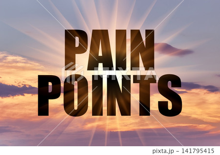 Pain points concept glowing on dramatic sunset sky Pain points concept glowing on dramatic sunset sky 141795415