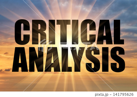 Critical analysis text against glowing sun rays in sunset sky 141795626