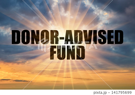 Donor-advised fund text against bright sun rays in morning sky Donor-advised fund text against bright sun rays in morning sky 141795699