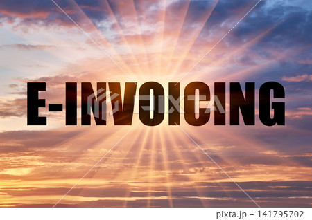 E-invoicing text against glowing sun rays in sunset sky E-invoicing text against glowing sun rays in sunset sky 141795702