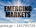 Emerging markets text against bright sun rays in blue sky 141795720