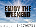 Enjoy The Weekend Concept on Bright Blue Day Sky with Sun Rays 141795731