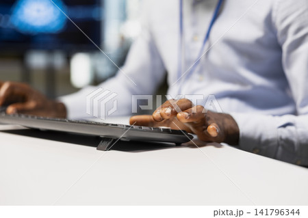 Close up of technician writing code snippets in modern office, adjusting program configurations. Tech company IT specialist running diagnostic tools on PC, monitoring API cloud services 141796344
