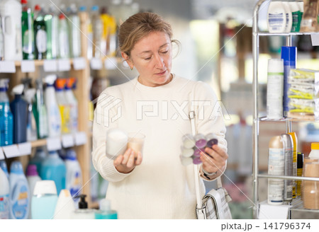 Female shopper chooses scented candles in supermarket for romantic evening Female shopper chooses scented candles in supermarket for romantic evening 141796374